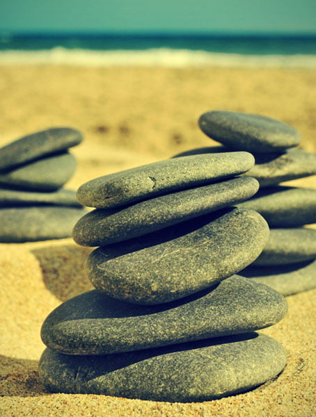 stones on the beach meditation-in-grass